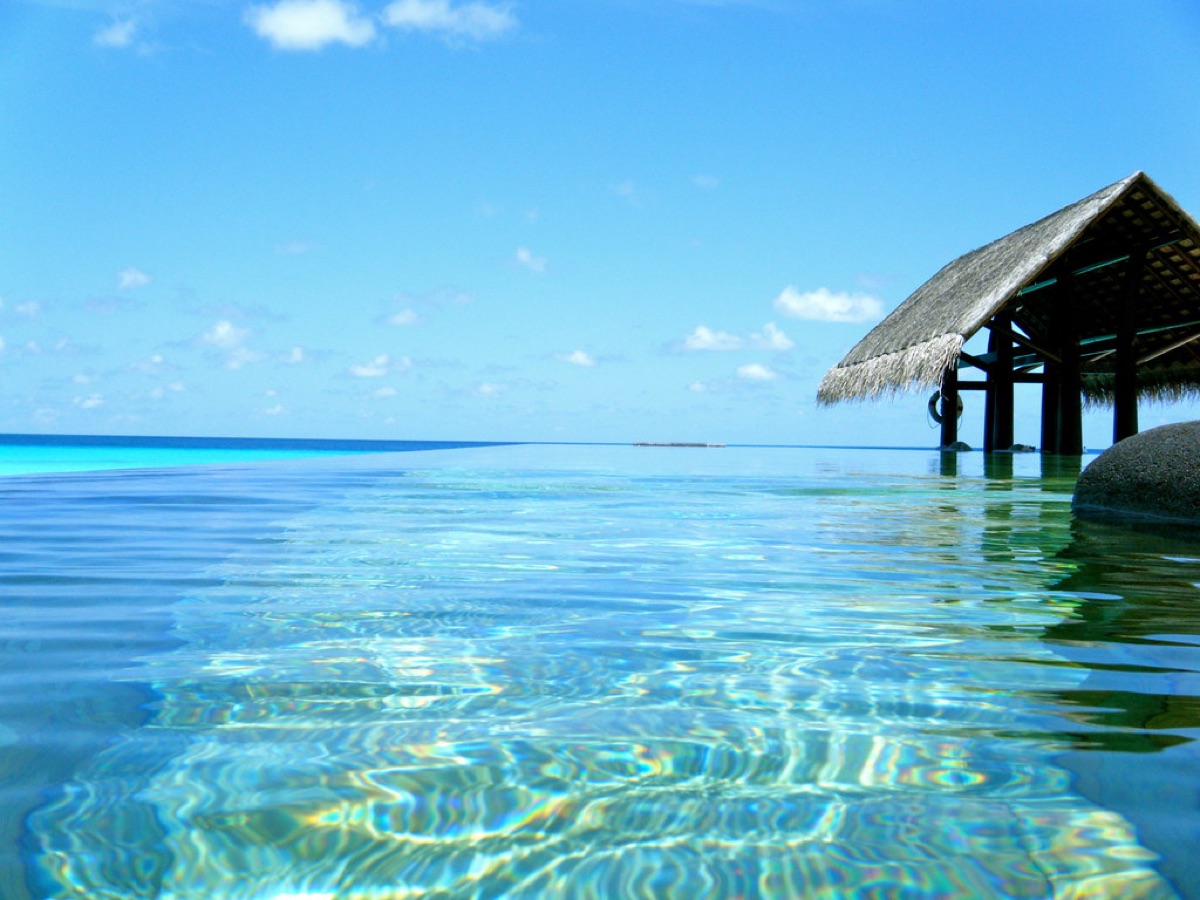 luxury villa infinity pool with sky reflection