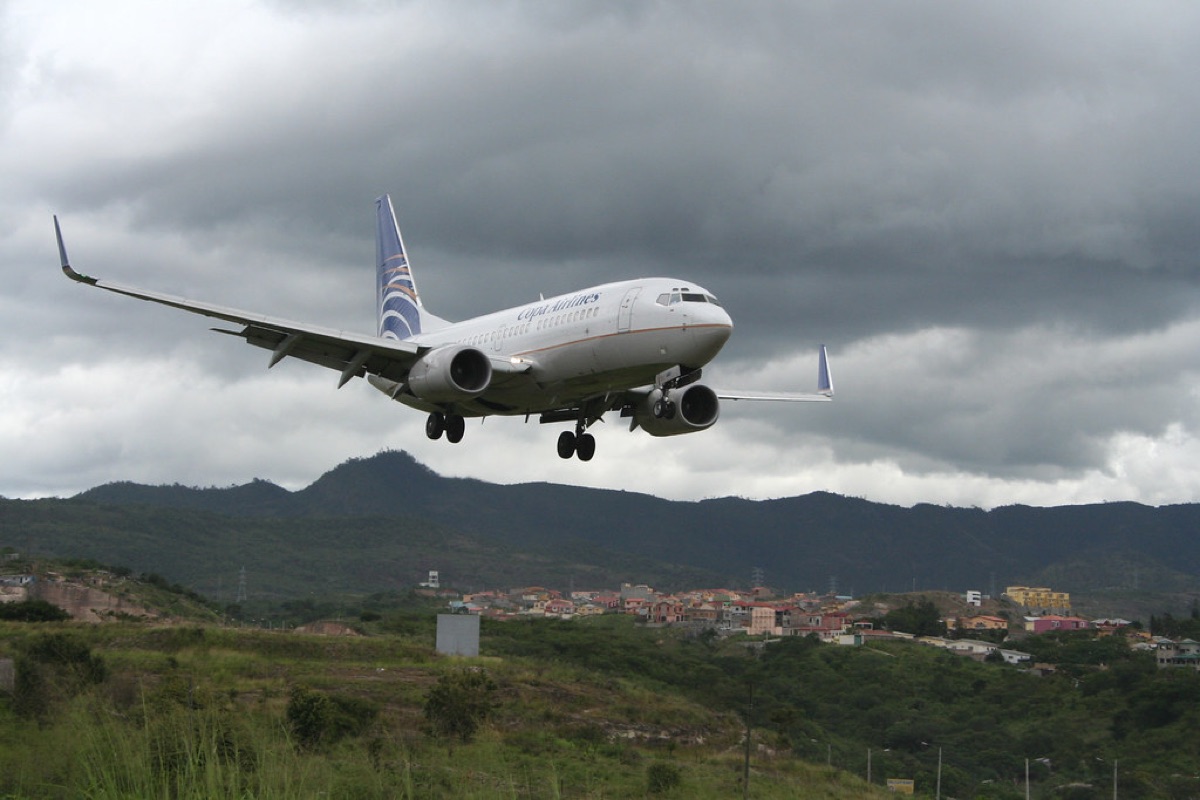 Airplane landing at airport with Tahiti and Borabora signs
