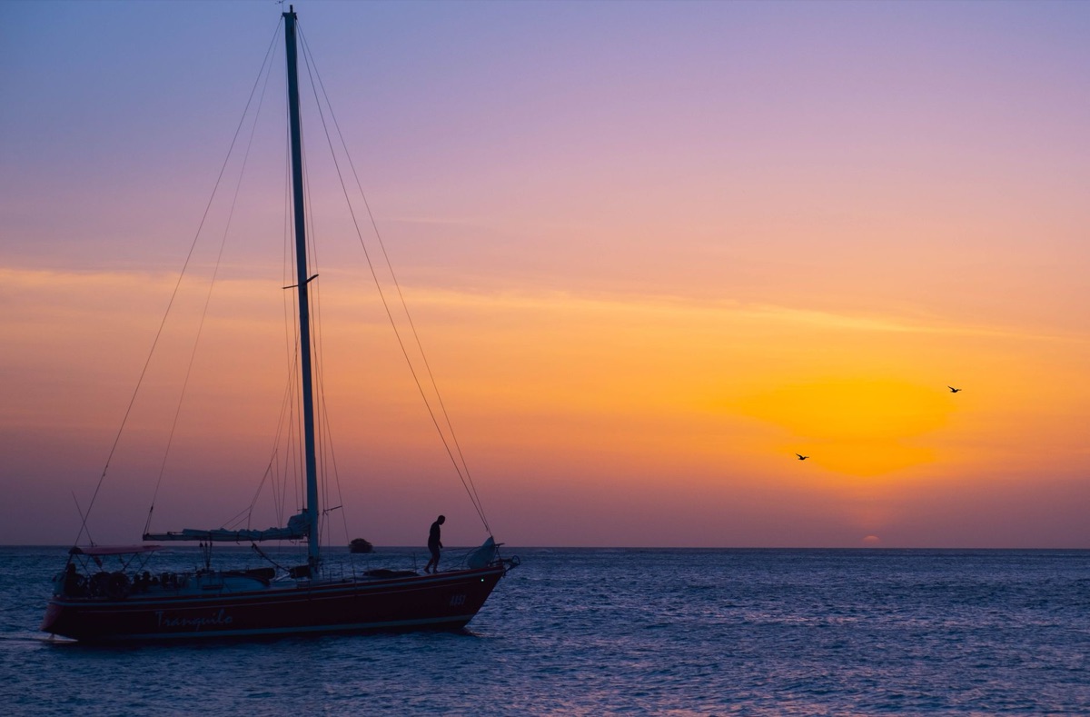 Sailboat with passengers watching sunset
