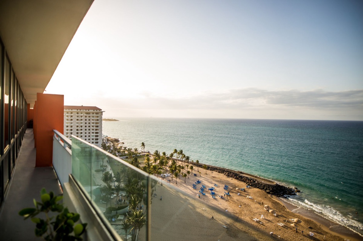 Resort suite with balcony and ocean view showcasing luxury amenities