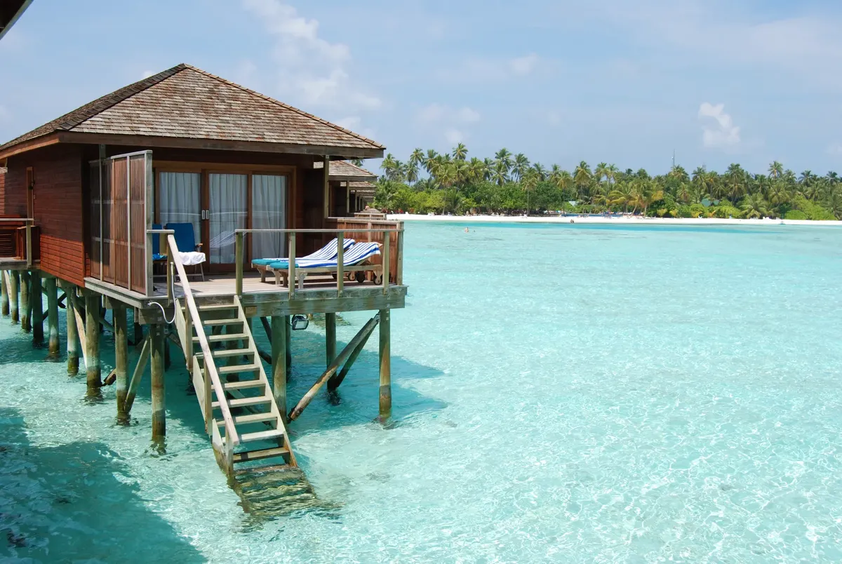 Stunning overwater bungalow surrounded by turquoise water, perfect for a serene tropical getaway.